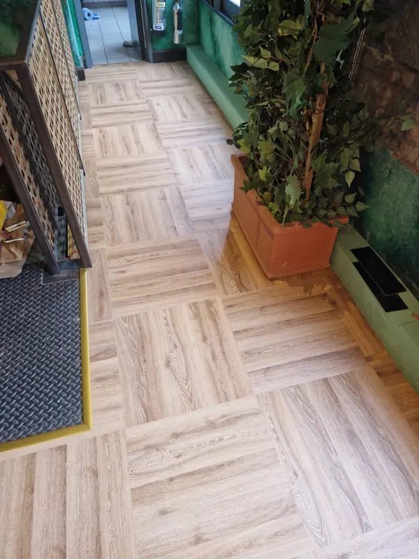 LVT beside the planters and lattice screen, with a flush mat by the stairs