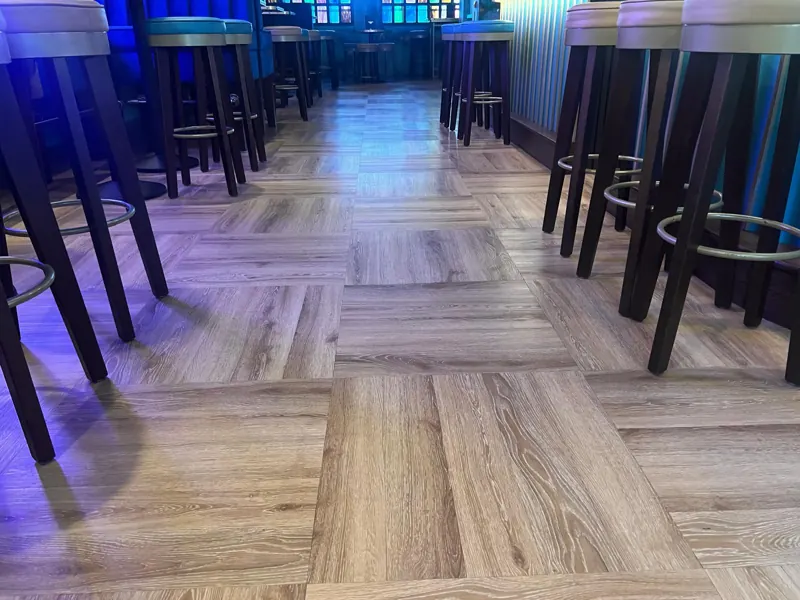 Parquet pattern running under the bar stools