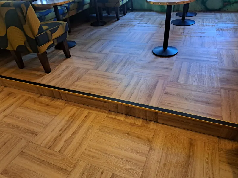 Raised seating platform with a nosed step edge