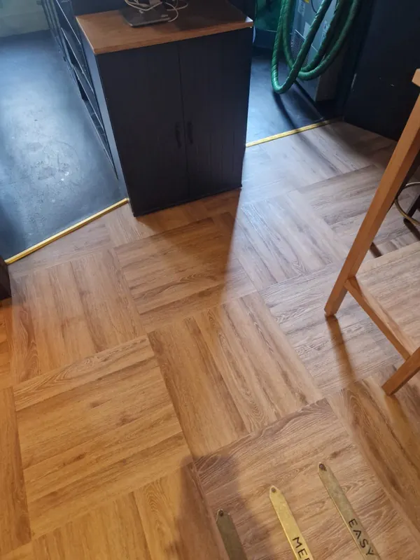 LVT meeting the doorway with a brass threshold strip