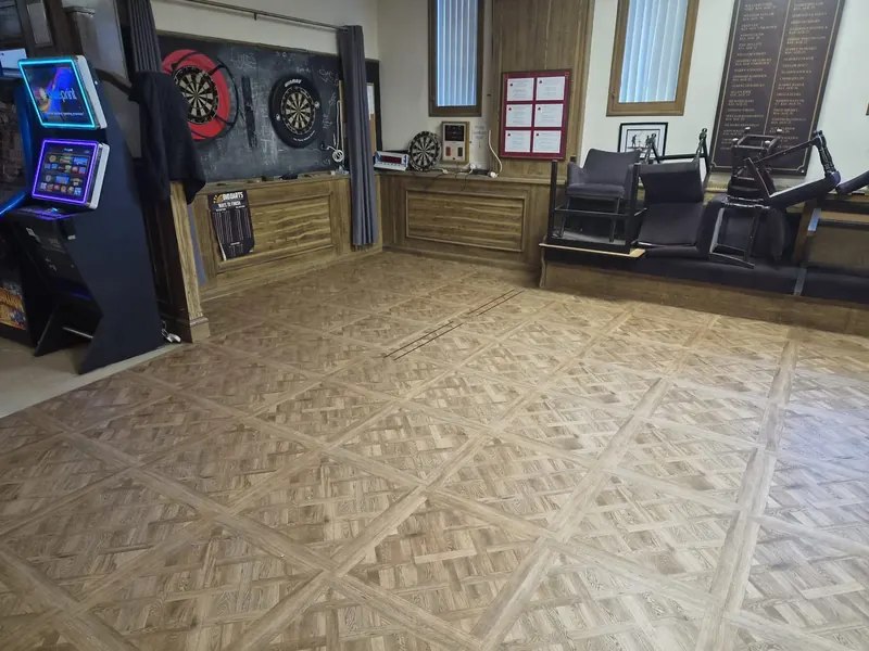 Darts area finished in Versailles-pattern LVT