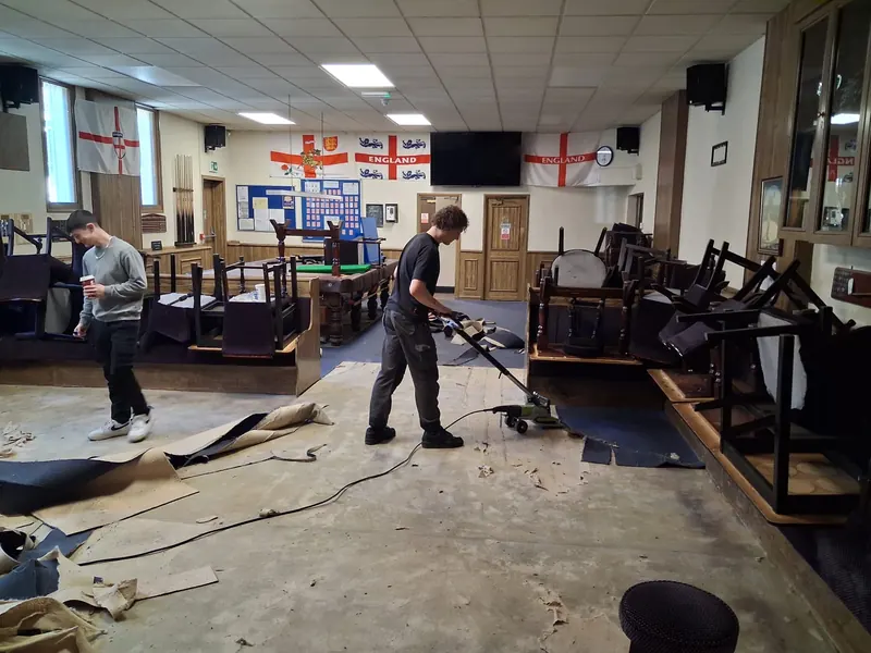 Lifting carpet round the raised seating