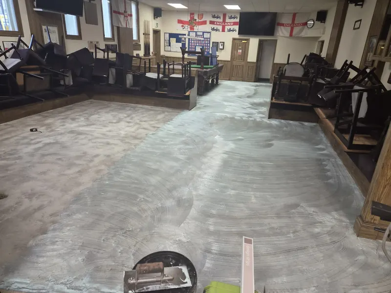 Adhesive spread across the room with a notched trowel