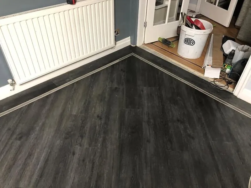 Dark oak LVT with the border running along the skirting
