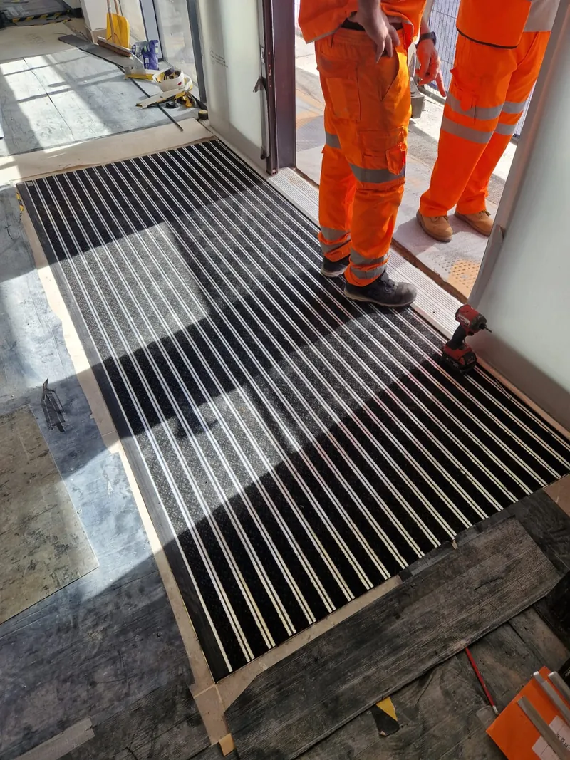 The Gradus mat fitted in its frame at the station doors, with the surrounding floor still protected
