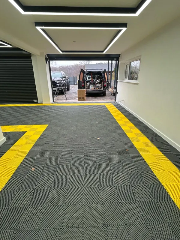Garage finished in PVC click tiles with a yellow border