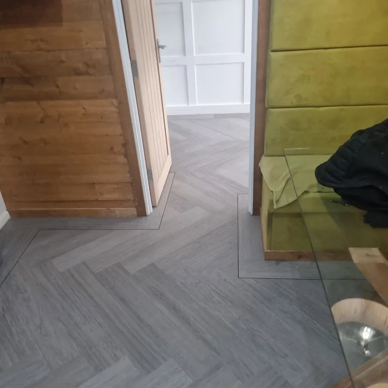 Herringbone framed with a plank border by the stairs