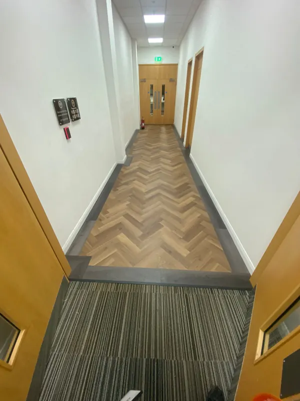Carpet tile at the entrance, herringbone beyond