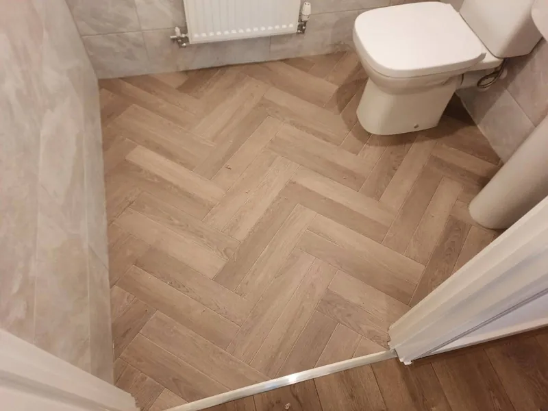 Herringbone LVT cut round the toilet in the cloakroom
