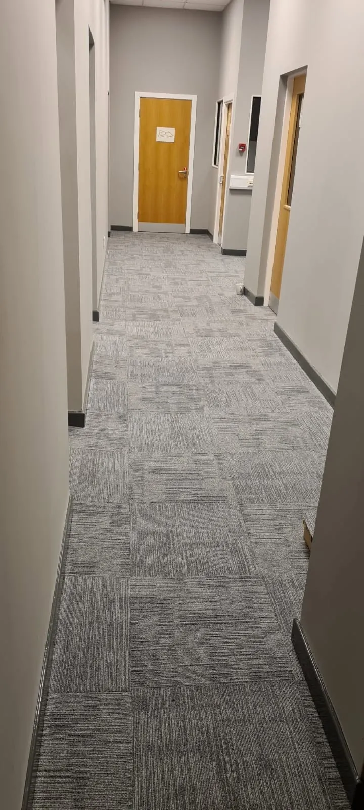 Carpet tiles along a side corridor