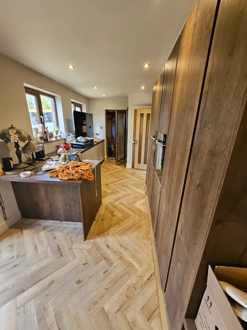 Herringbone floor running past the kitchen island