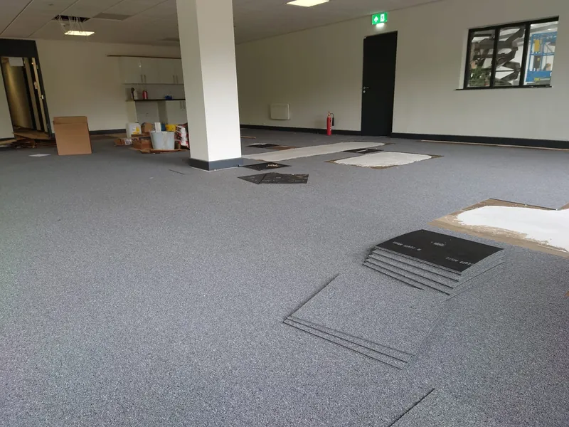 Carpet tiles going down round the floor boxes
