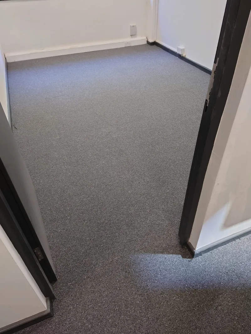 Carpet tiles finished to the wall
