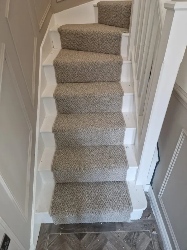 Inset runner with whipped edges up the stairs