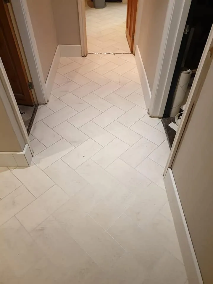 Stone-effect herringbone running down the hallway