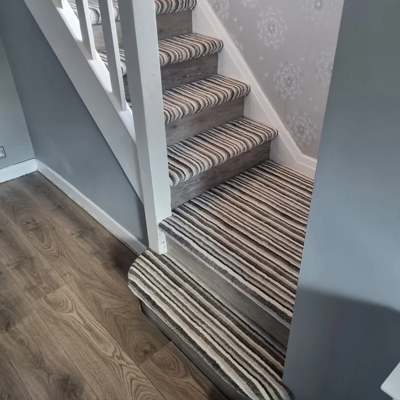 Stripes running straight down the winding stairs